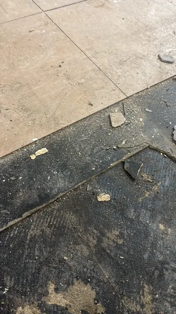 Black bitumen mastic floor removal in a SW17 flat